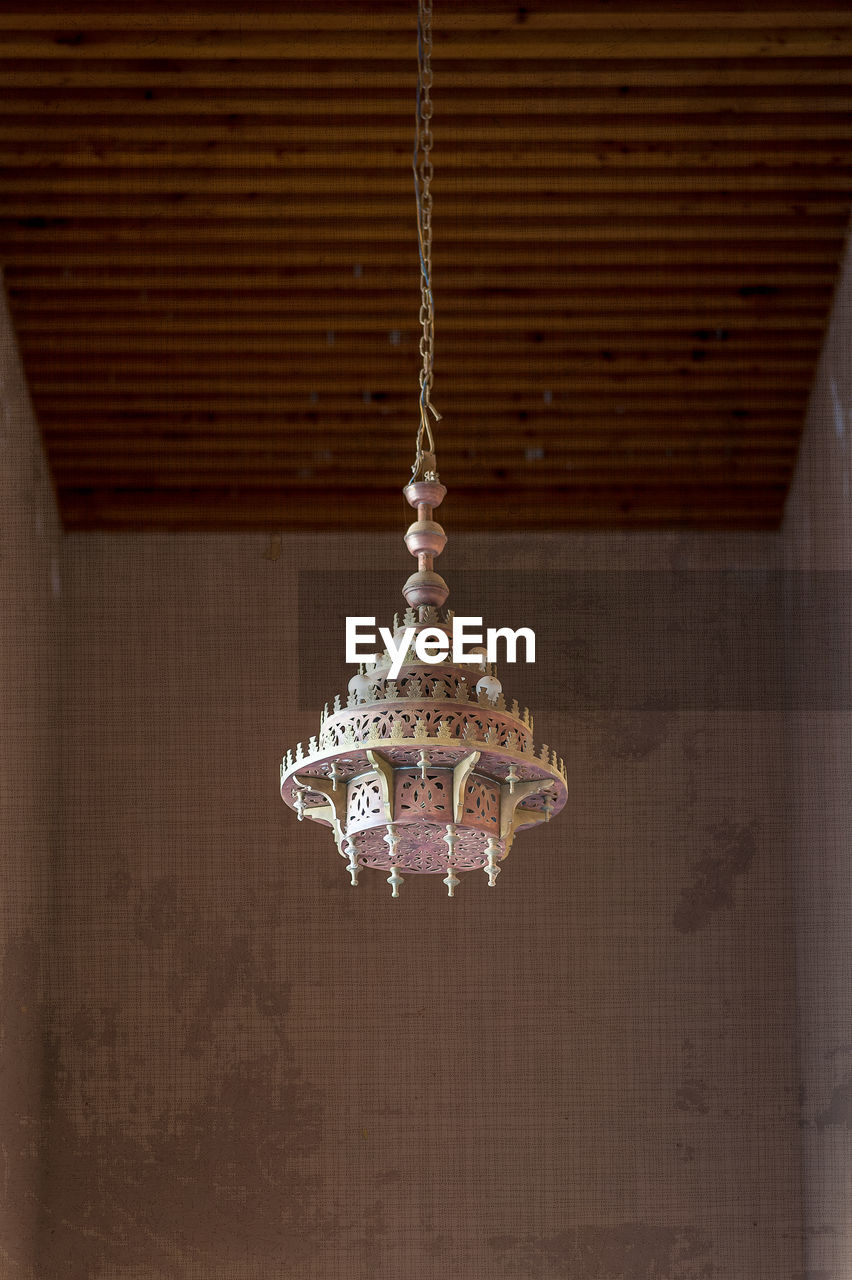 Close-up of chandelier hanging against wall