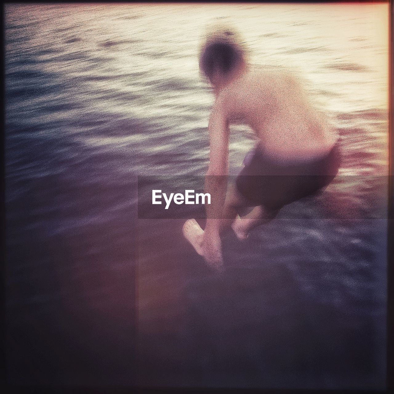 High angle view of boy jumping in lake