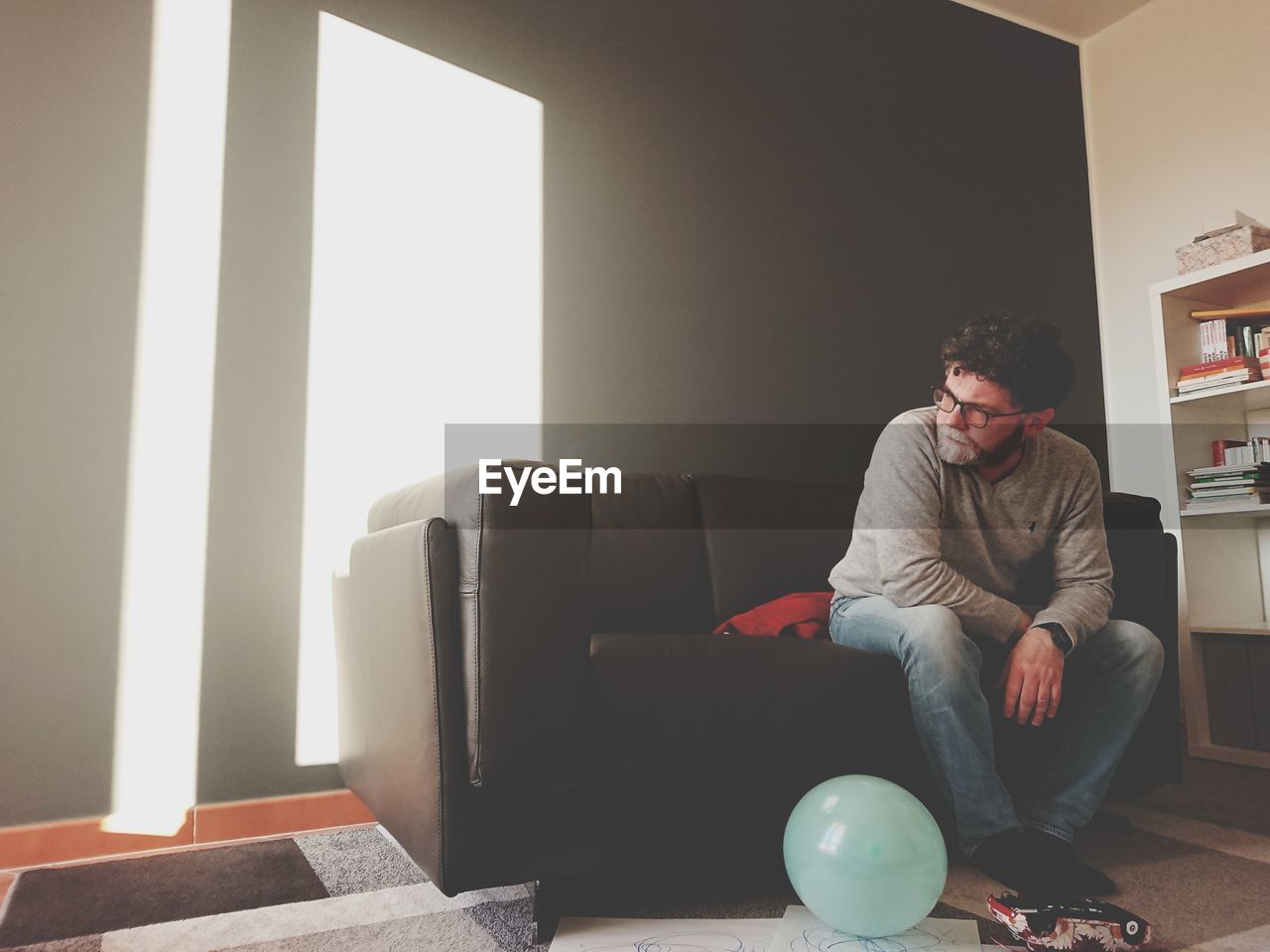 Man sitting on sofa at home