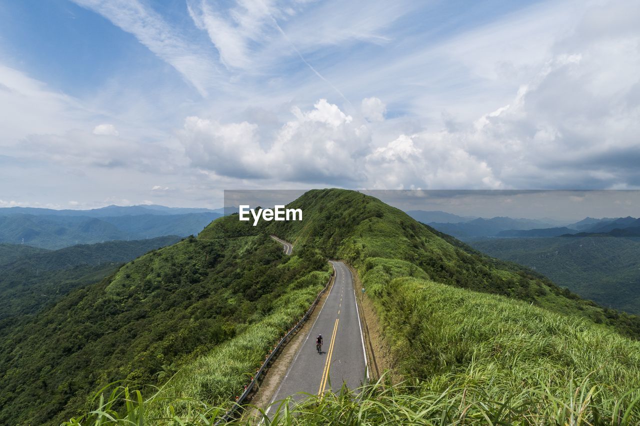 Panoramic view of road leading towards mountains against sky