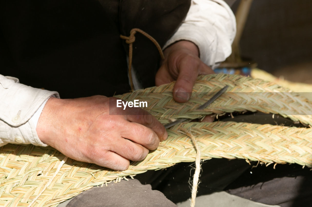 cropped hand of man working on table