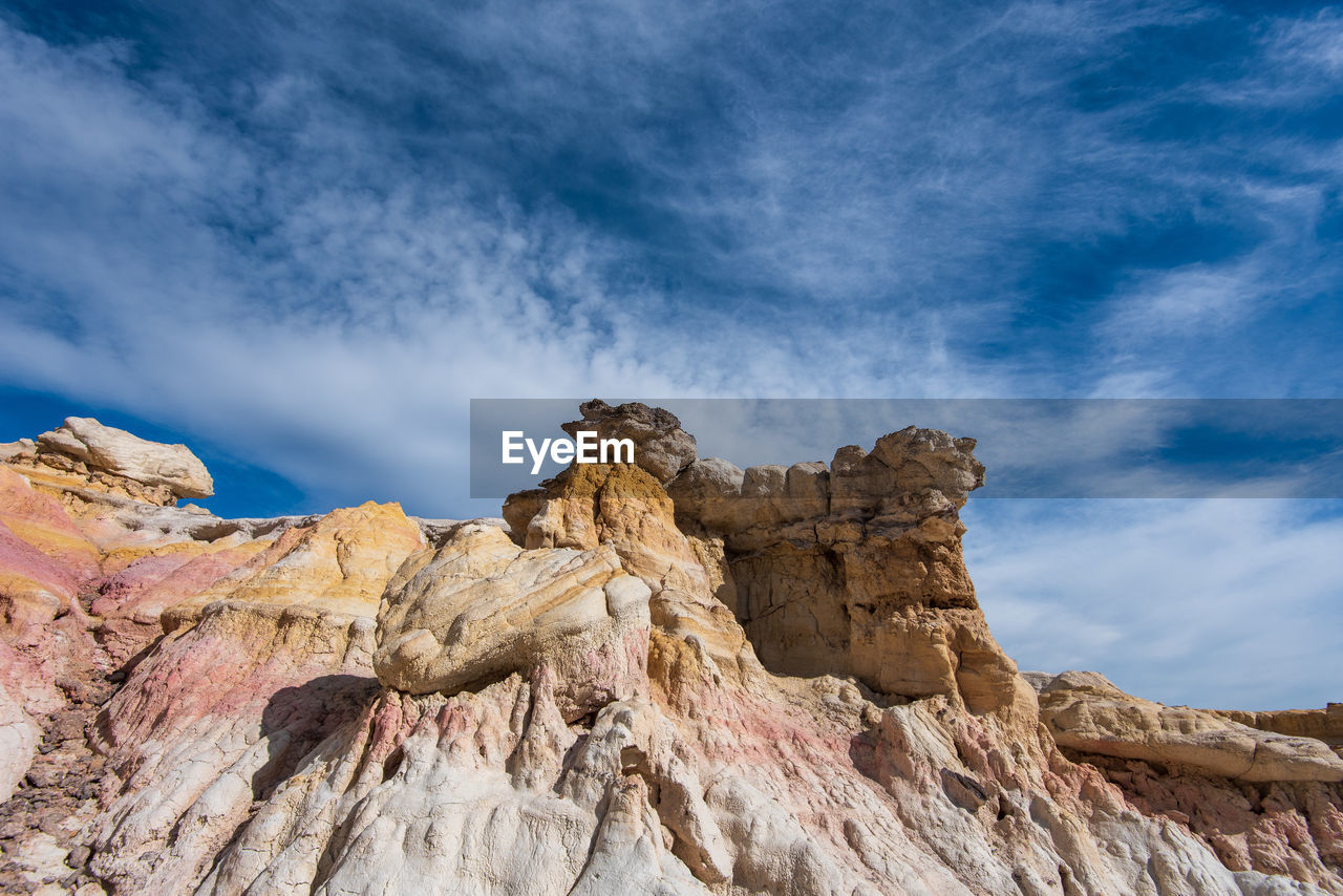 Landscape of white, pink and yellow rock formations at interpretive paint mines in colorado