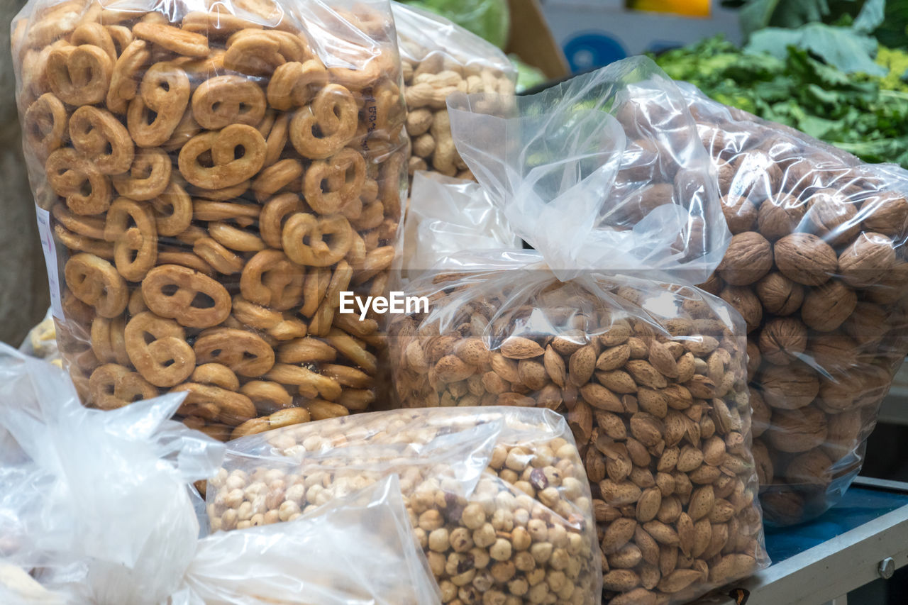 Typical apulian taralli, hazelnuts, almonds and walnuts in transparent plastic bags