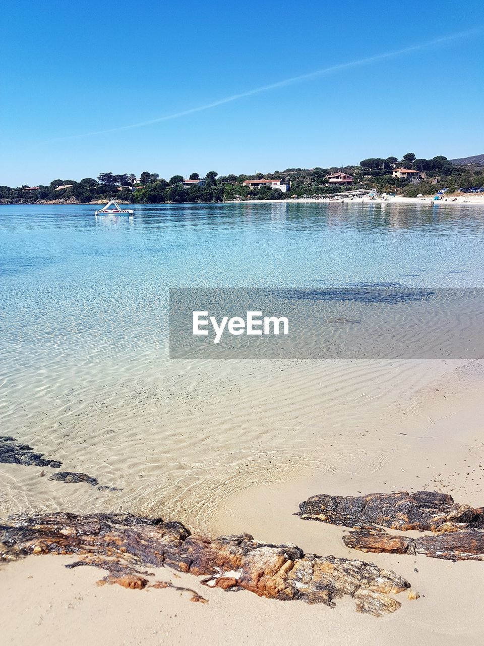 VIEW OF BEACH AGAINST BLUE SKY