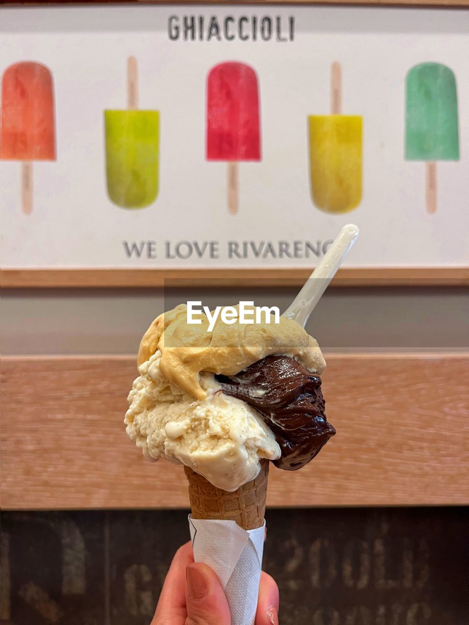 food, hand, food and drink, frozen food, ice cream, sweet food, holding, ice cream cone, frozen, sweet, one person, dairy, dessert, cone, unhealthy eating, temptation, freshness, fast food, gelato, lifestyles, personal perspective, cold temperature, snack, close-up, leisure activity