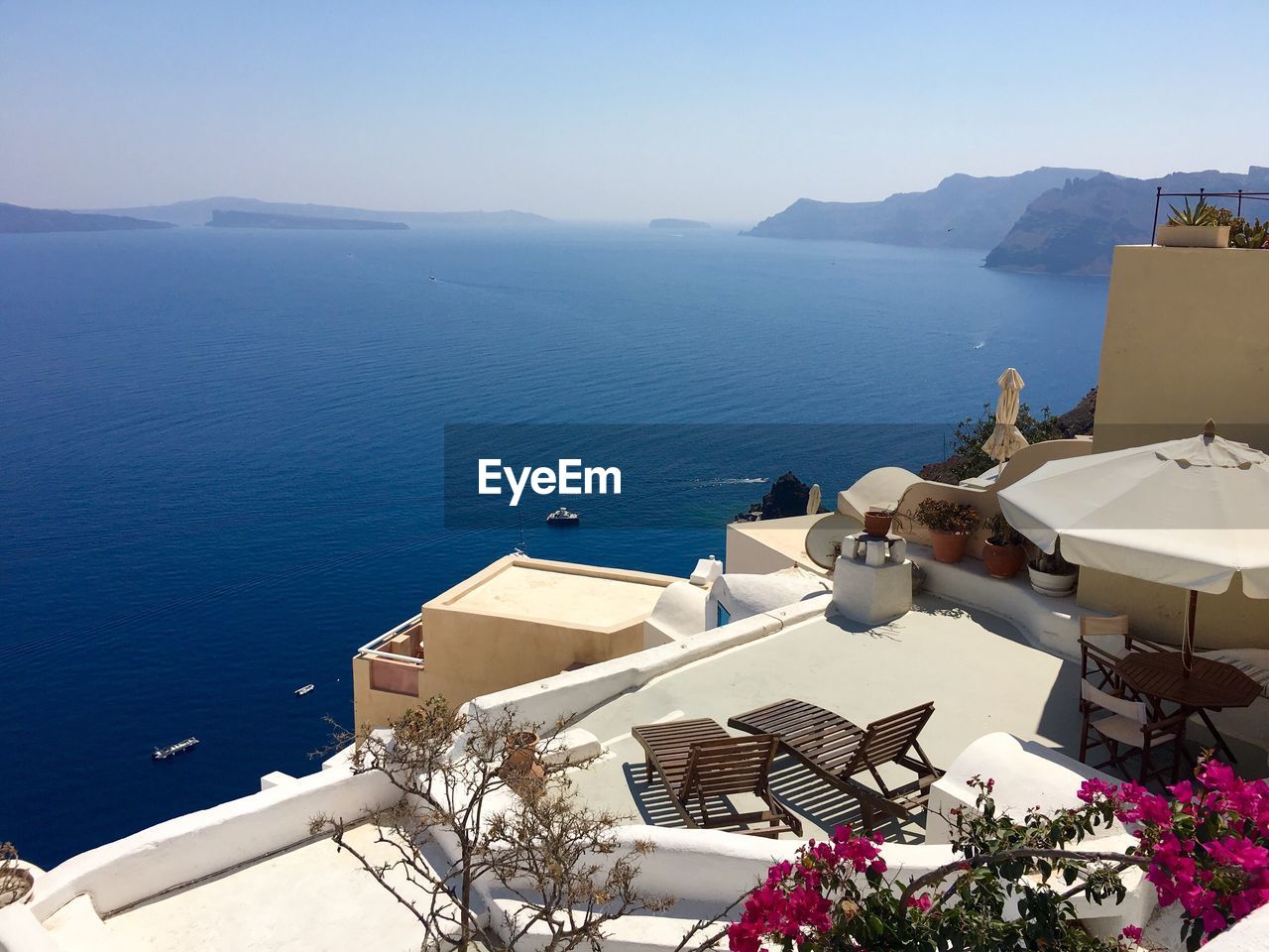 High angle view of buildings at santorini by blue sea