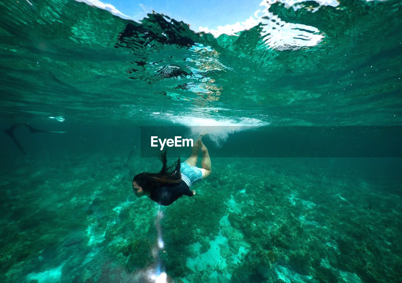 Woman swimming undersea