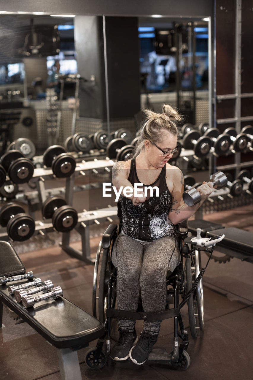 Woman on wheelchair training in gym