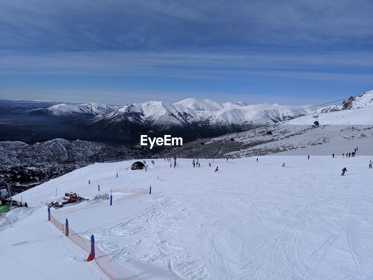 GROUP OF PEOPLE ON SNOWCAPPED MOUNTAIN AGAINST SKY