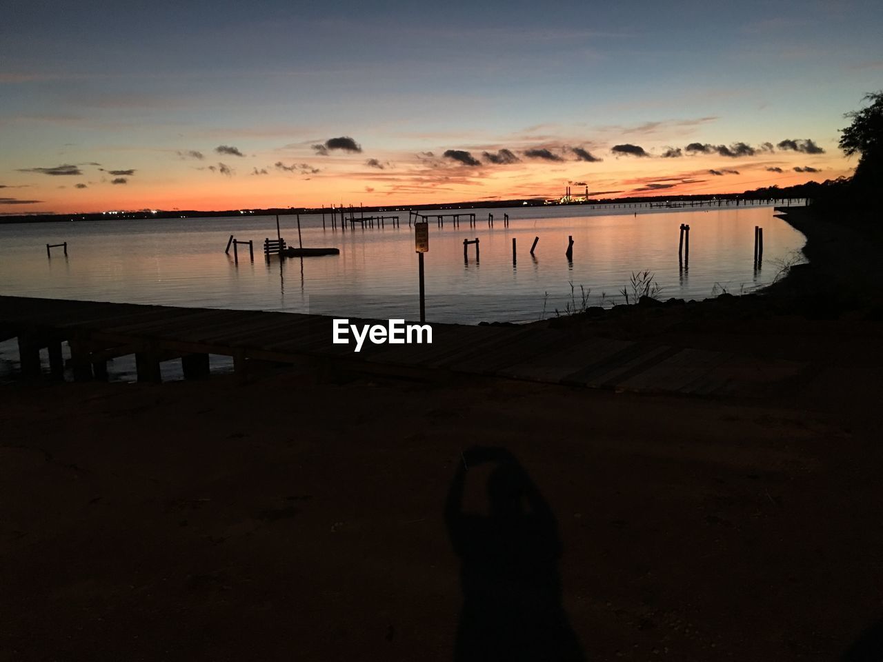 SILHOUETTE PERSON AT BEACH AGAINST SKY DURING SUNSET