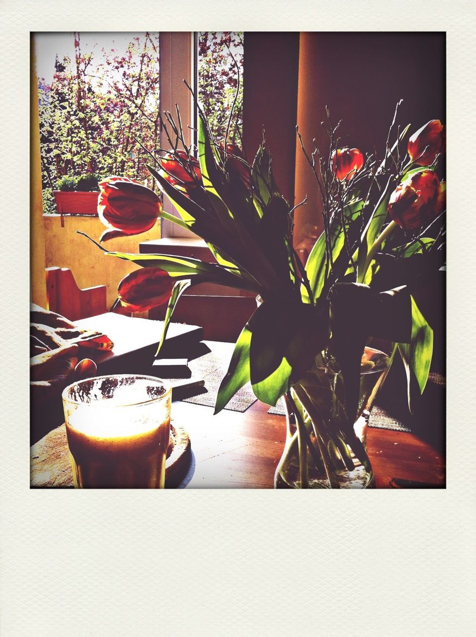 Coffee with flower vase on table at home