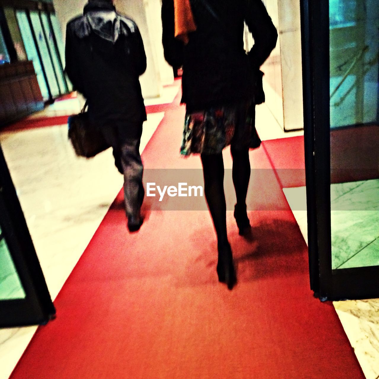 WOMAN STANDING ON TILED FLOOR