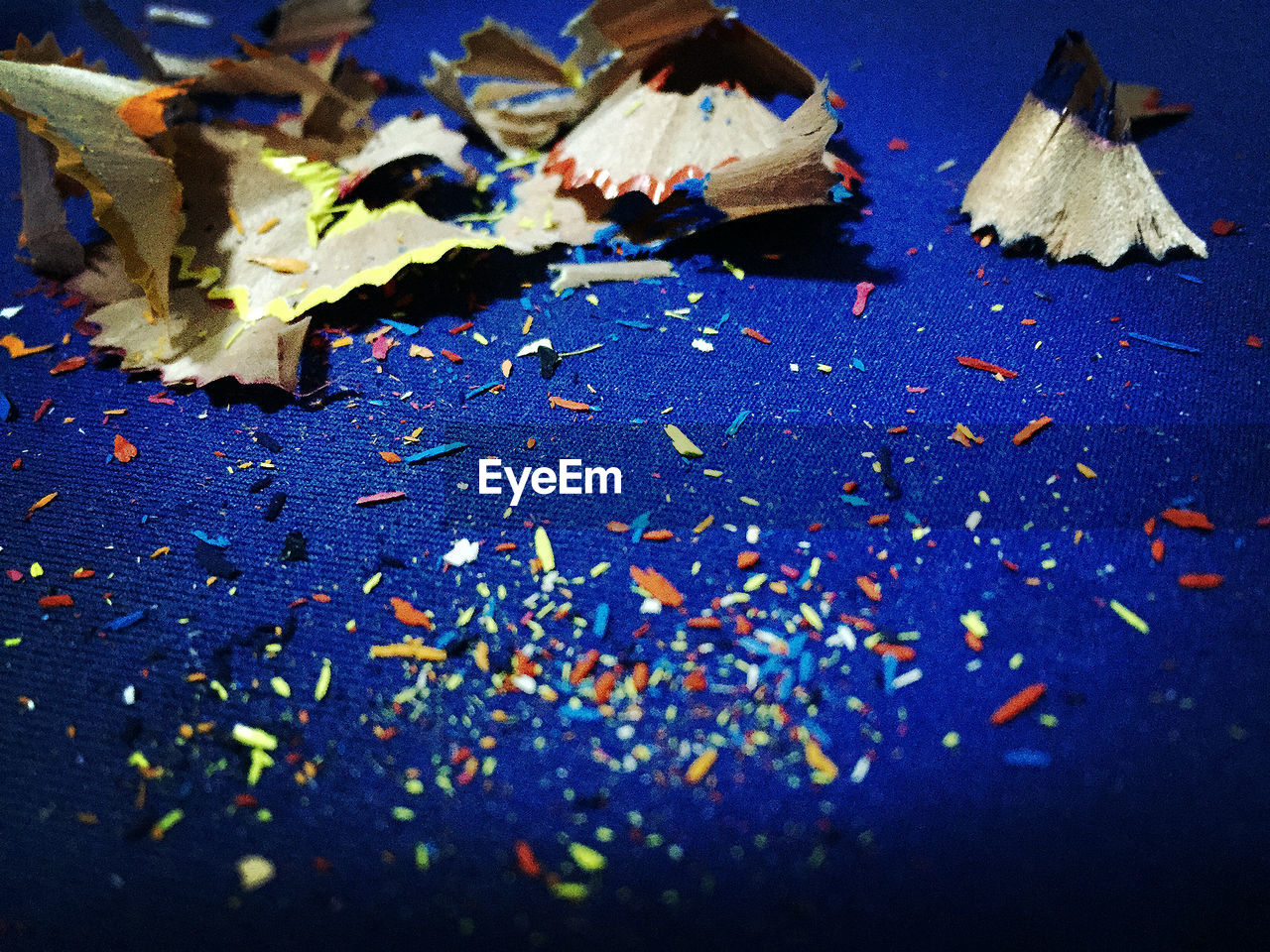 Pencil shavings on blue table