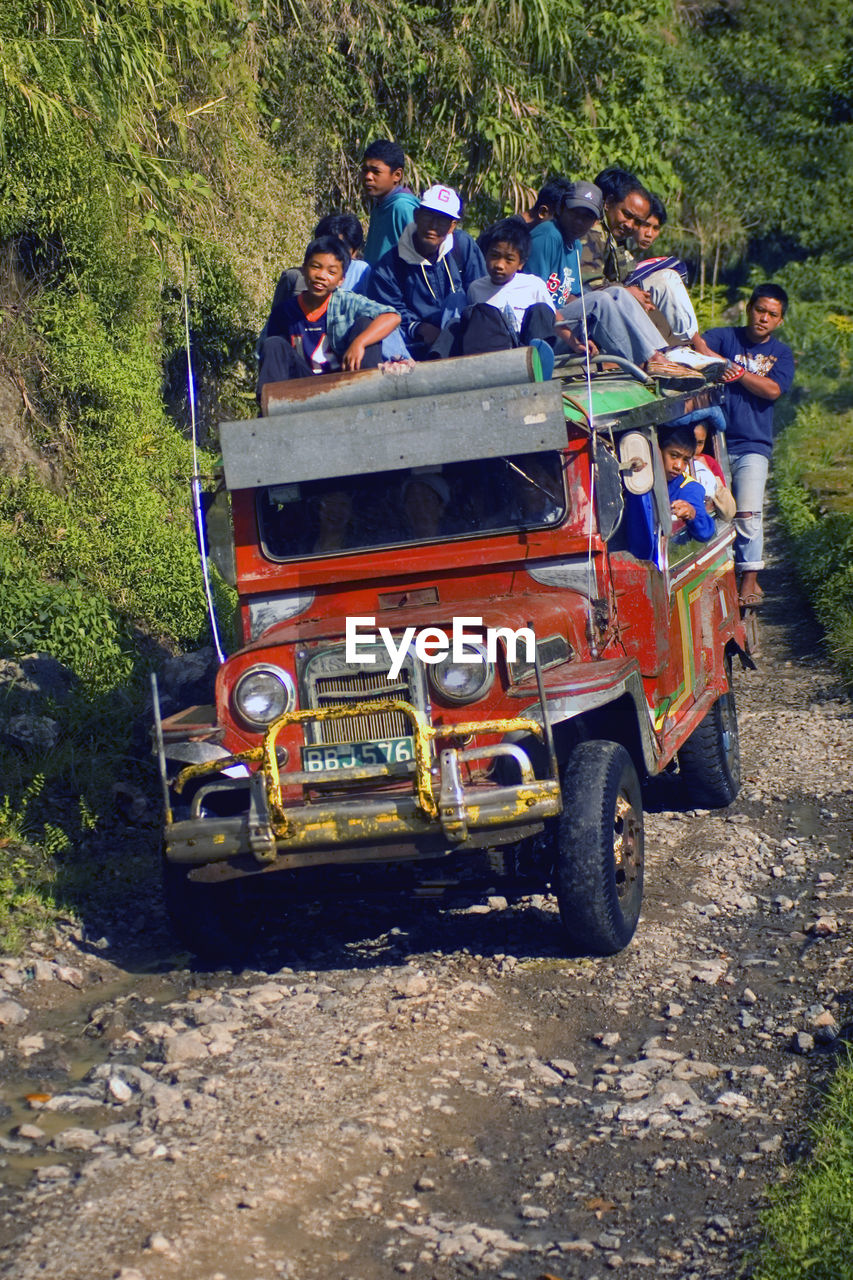 HIGH ANGLE VIEW OF PEOPLE RIDING MOTORCYCLE ON CART