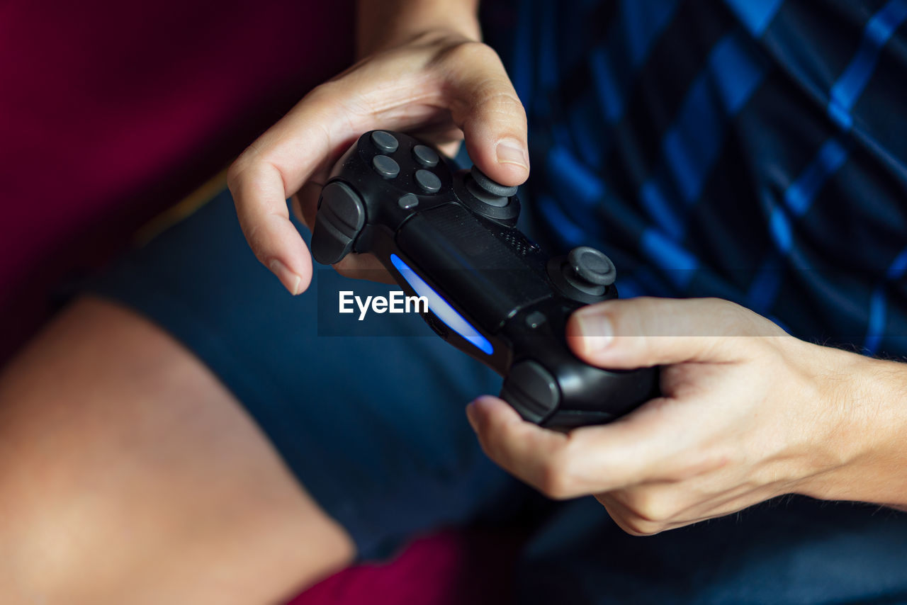 Close-up of a person playing the game console in the quarantine period