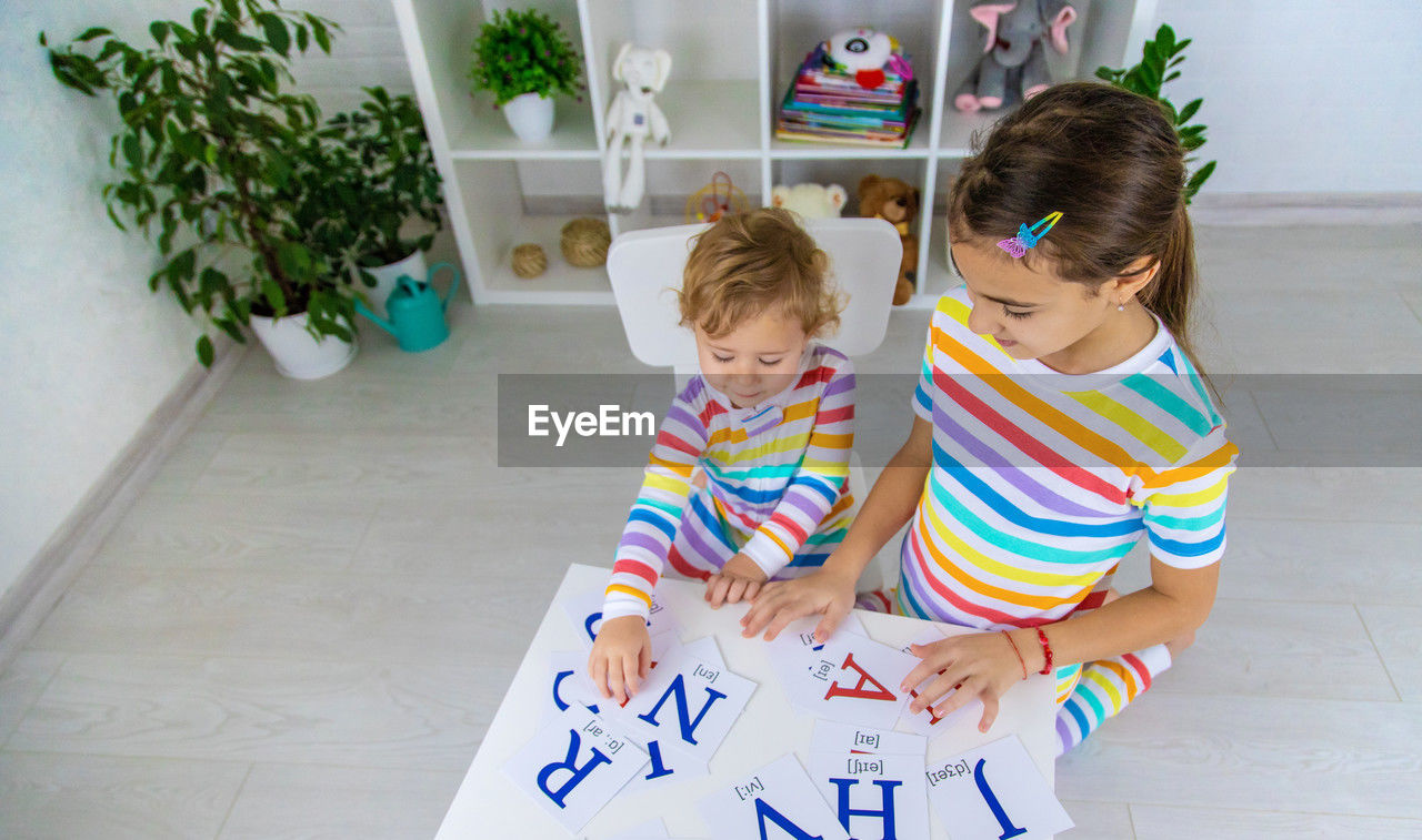 high angle view of cute girl playing with toy blocks