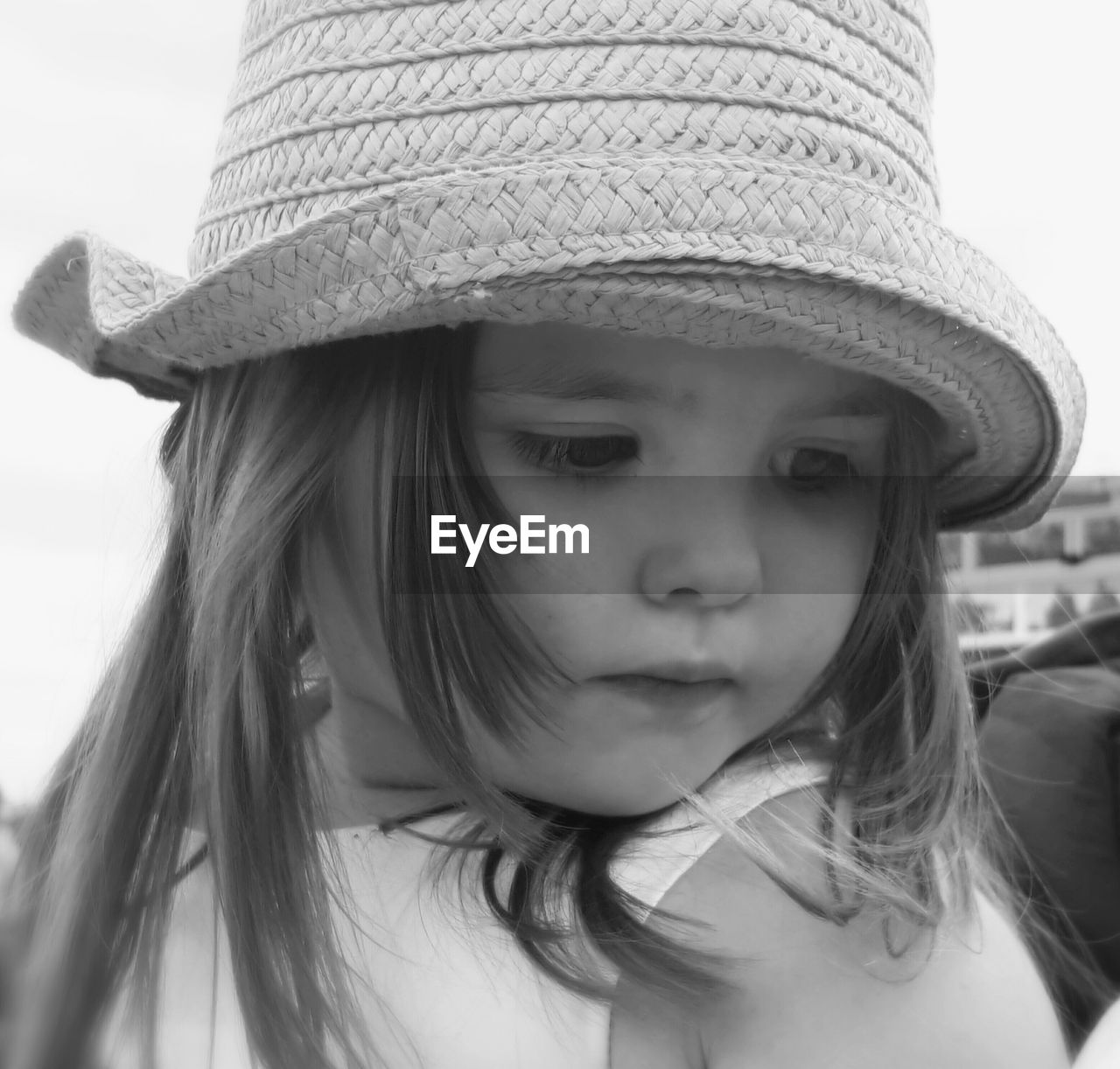 Close-up of cute girl wearing hat while looking down