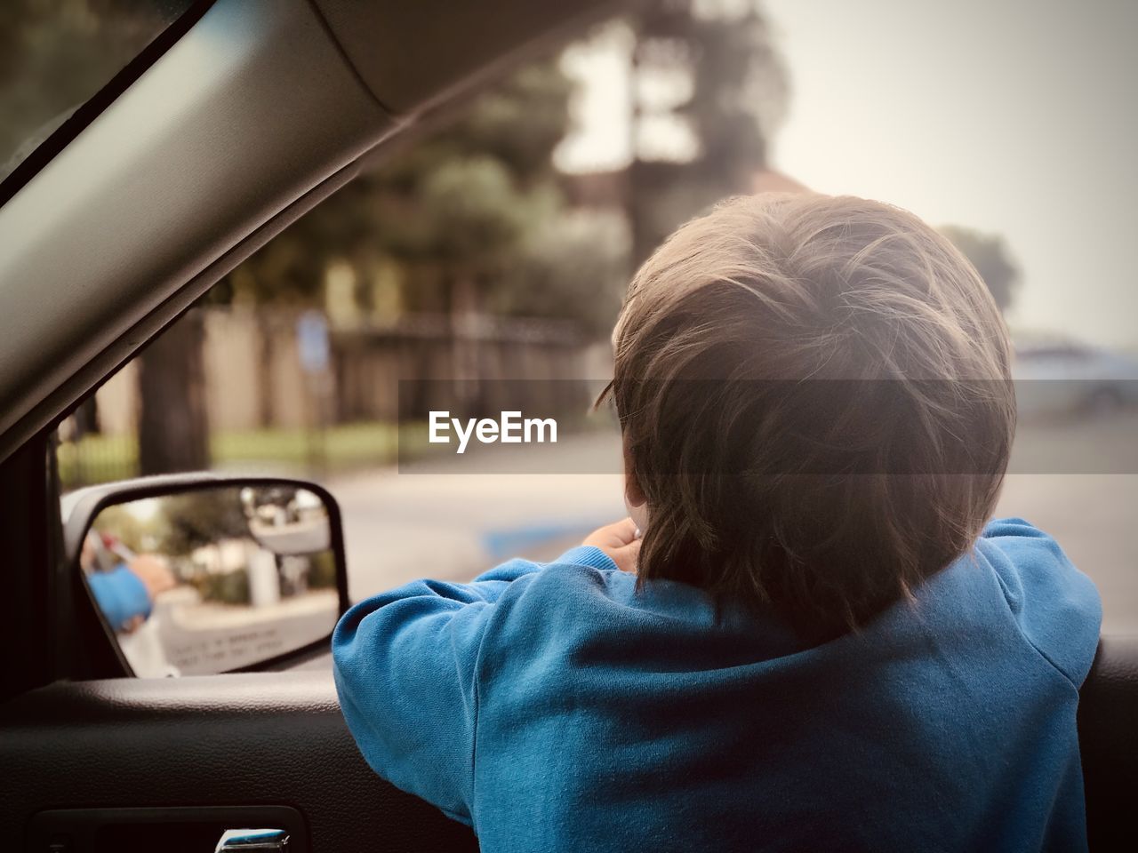 Rear view of boy in car