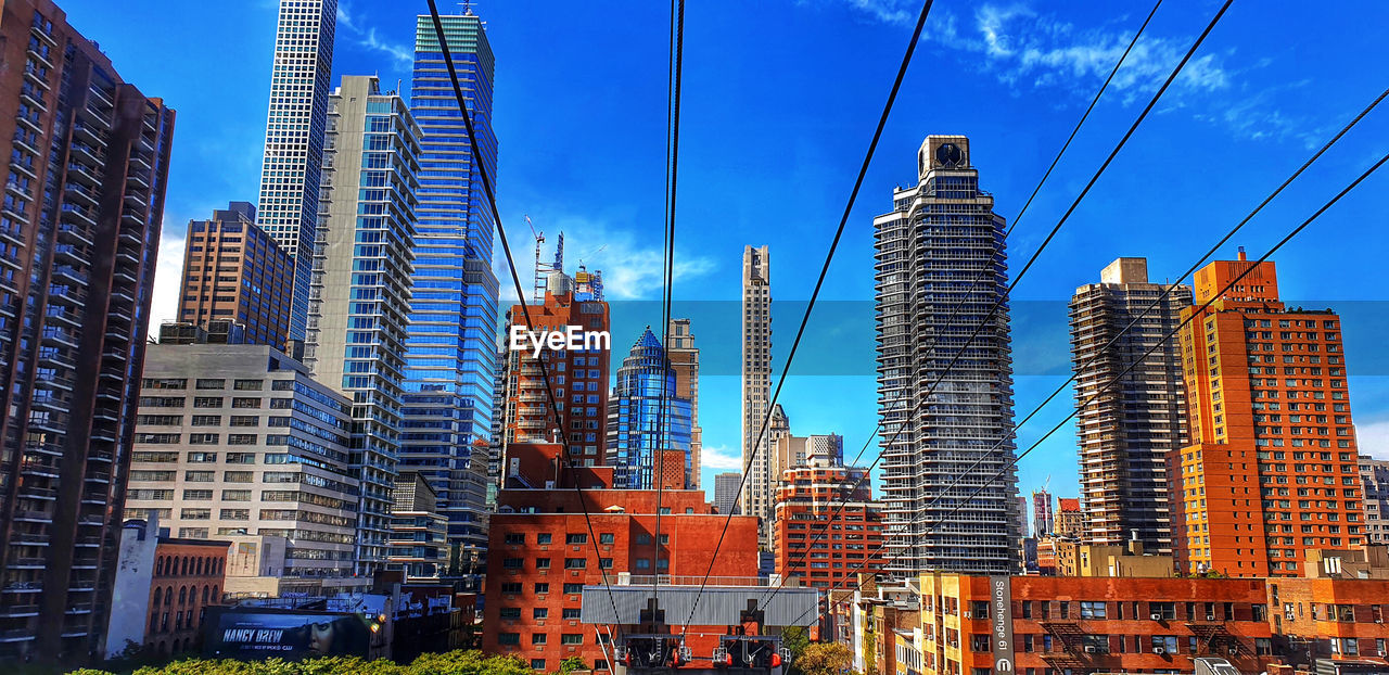 MODERN BUILDINGS IN CITY AGAINST SKY