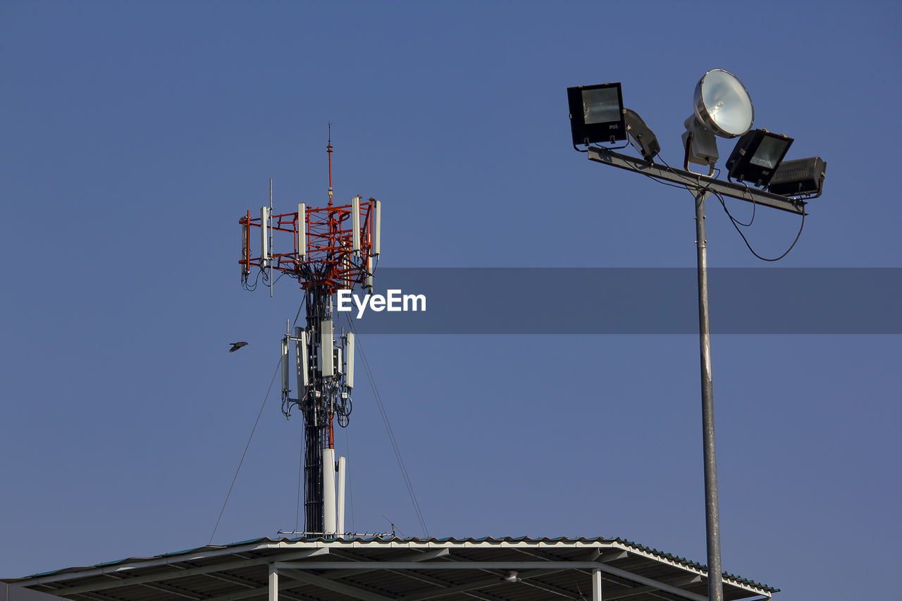 Low angle view of communications tower against sky