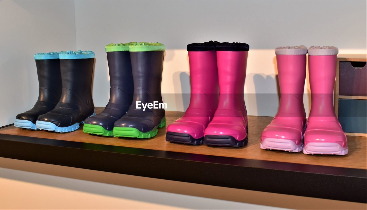 Close-up of rubber boots on table