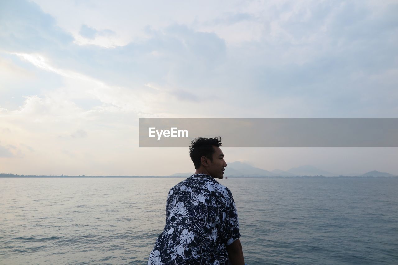 Man looking at sea against sky