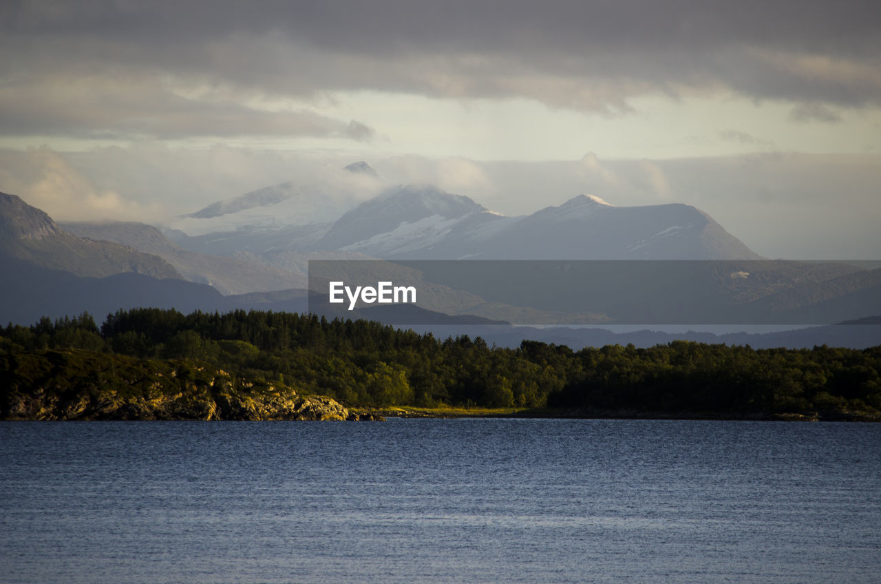 Scenic view of lake against cloudy sky