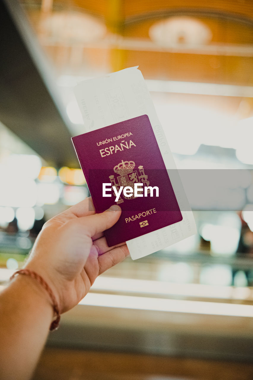 Travelers clutching passport and ticket at the airport