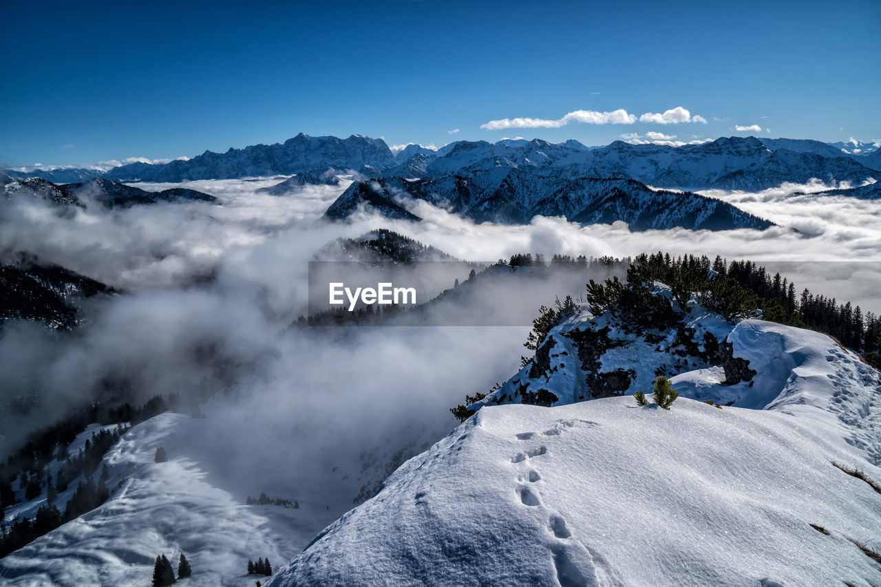 Scenic view of snow covered mountains against sky