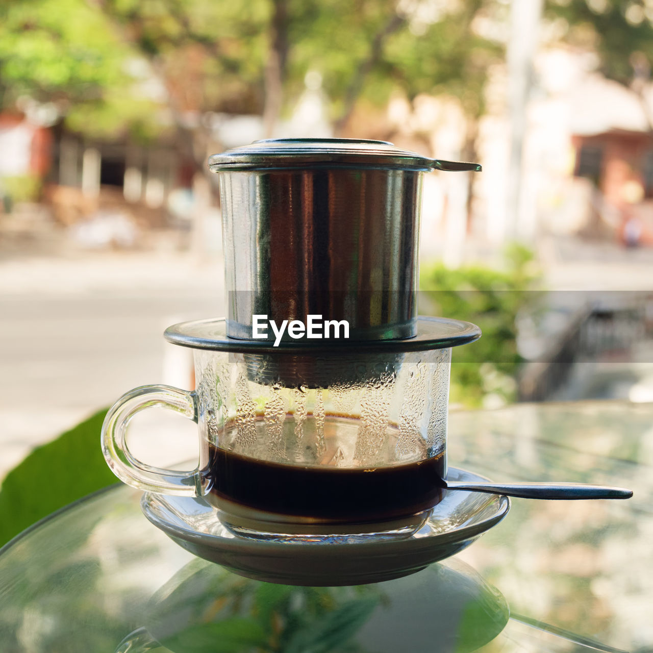 Drip black coffee in vietnamese style with condensed milk on a glass. method of making coffee.