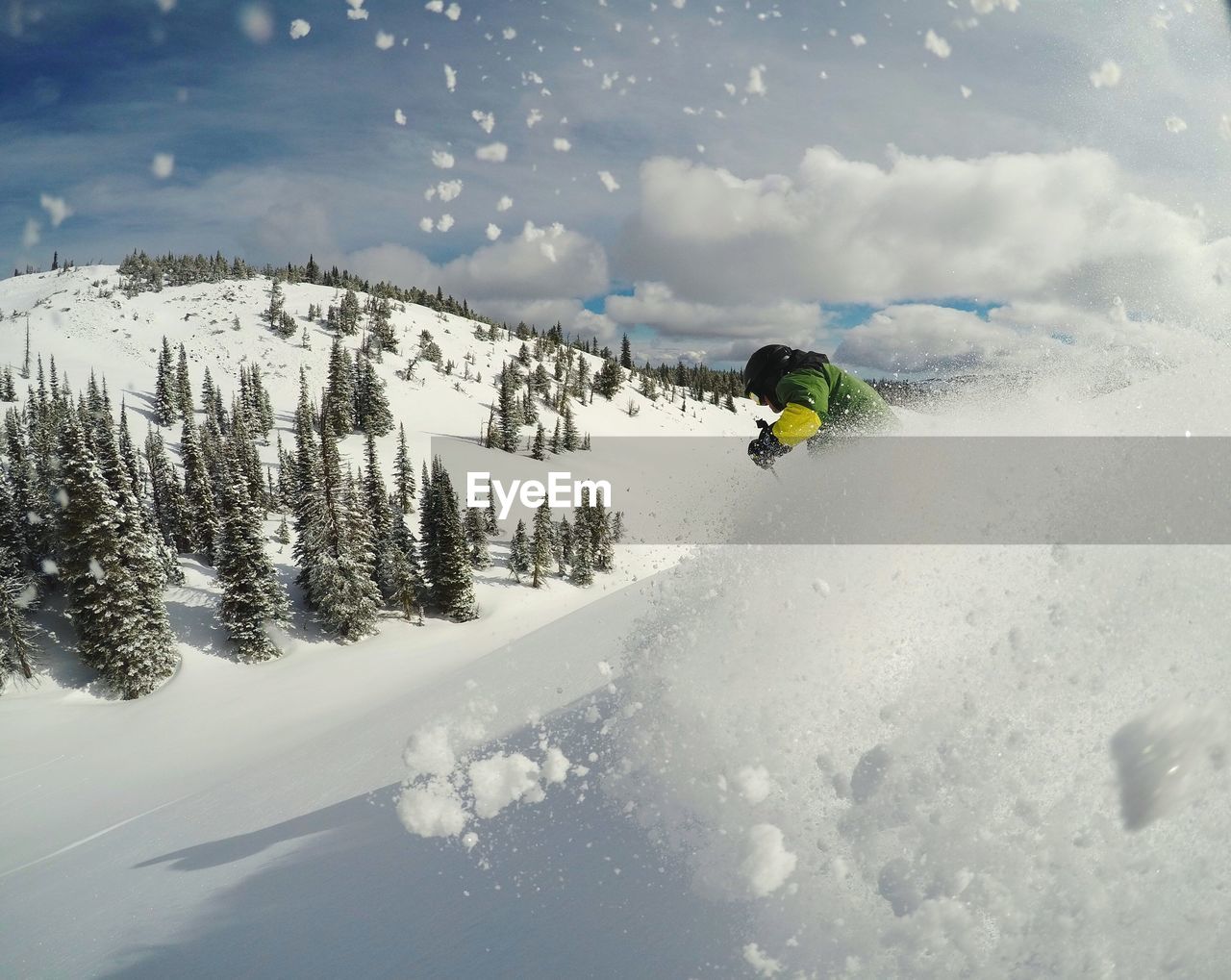 Rear view of man skiing on snowcapped mountain against sky