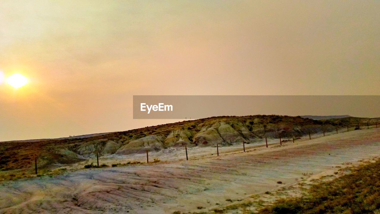 SCENIC VIEW OF LANDSCAPE AGAINST SKY AT SUNSET