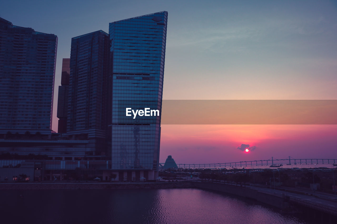 Modern buildings in city at sunset