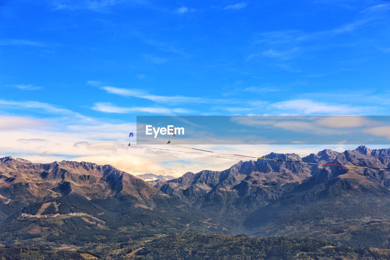 Scenic view of mountains against blue sky