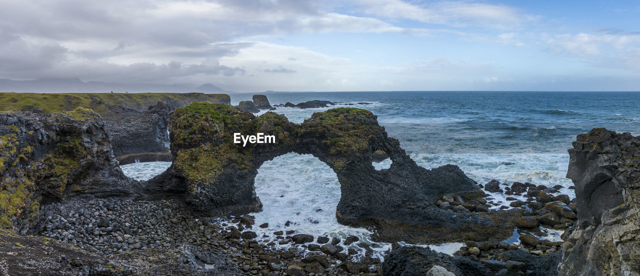 SCENIC VIEW OF ROCKS ON BEACH AGAINST SKY