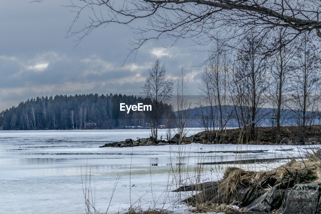 Scenic view of lake against sky during winter