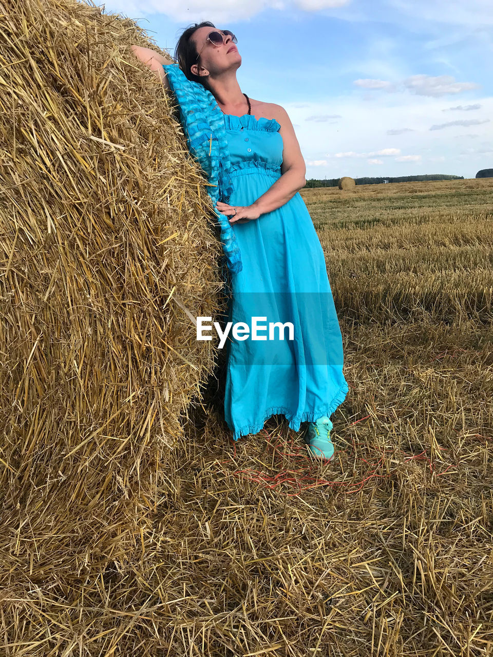 WOMAN STANDING IN FARM