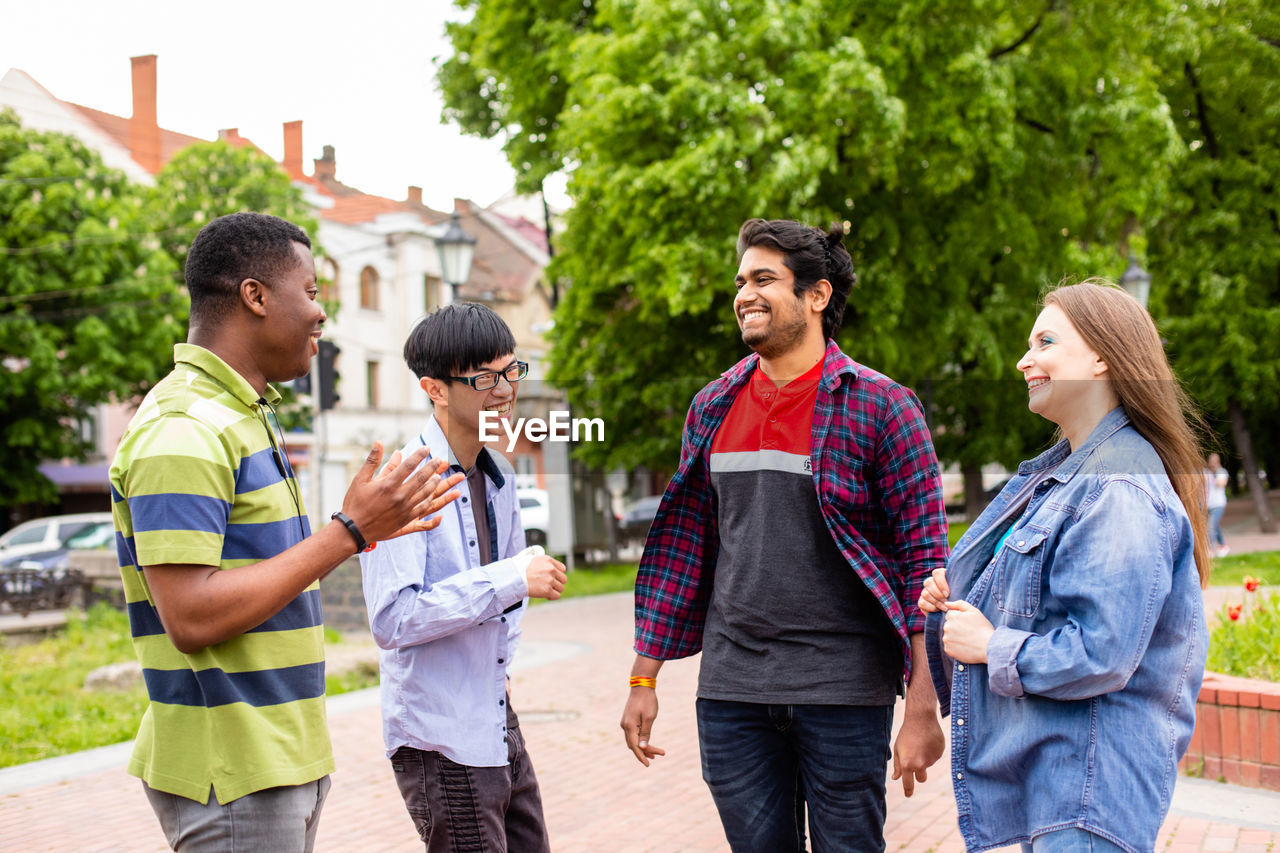 YOUNG COUPLE STANDING WITH TEXT ON PEOPLE