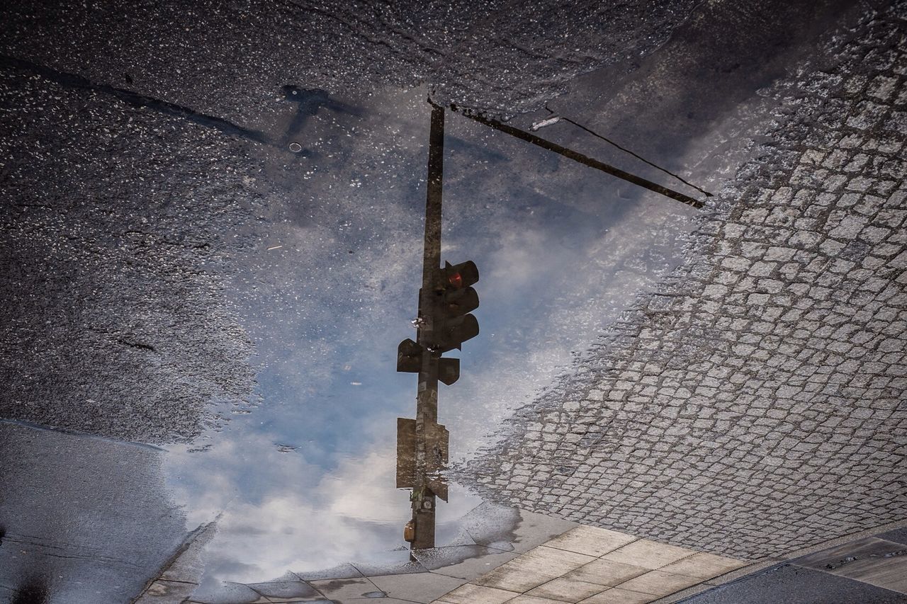 Reflection of traffic lights in a puddle