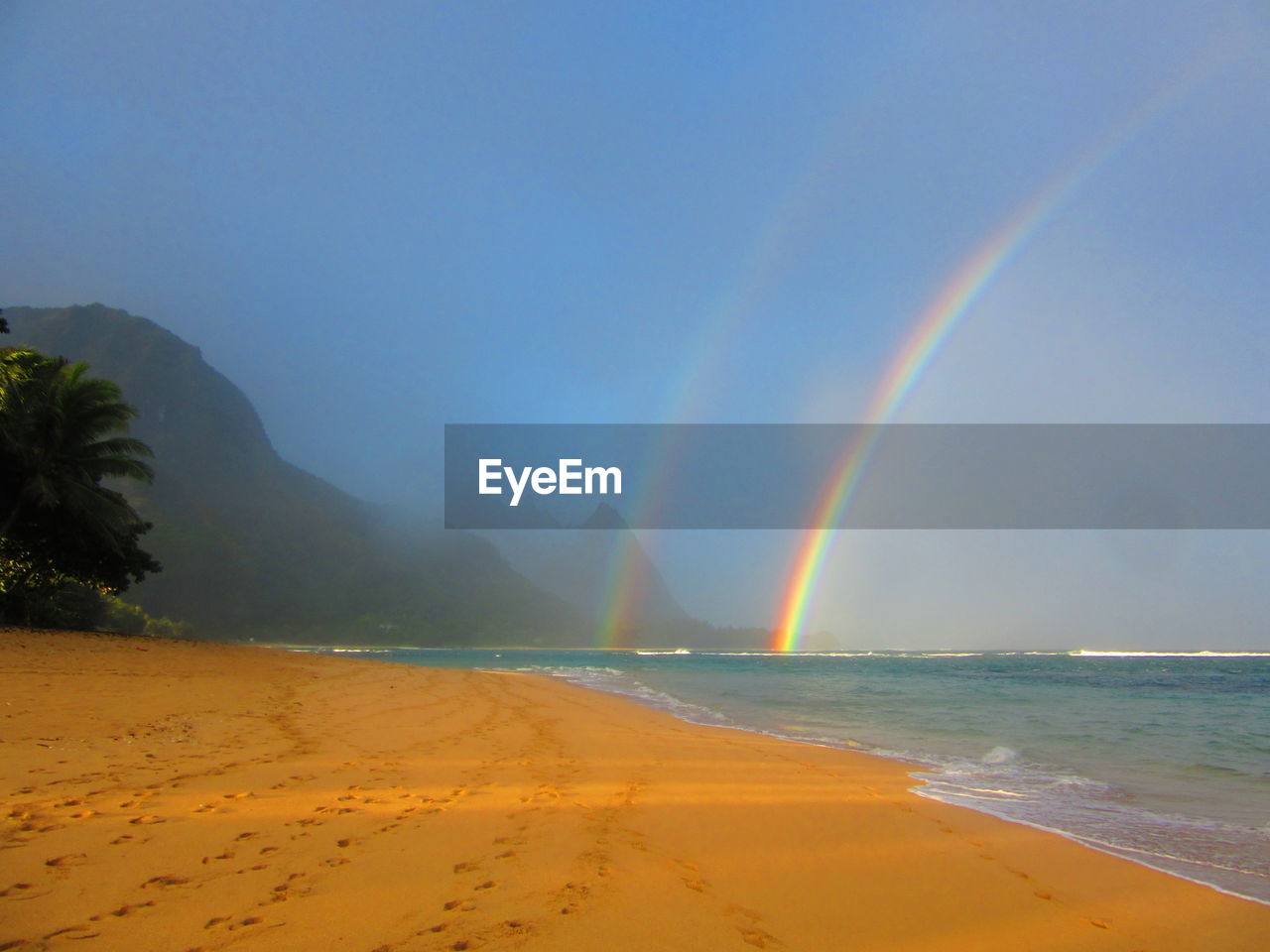 Scenic view of beach against blue sky