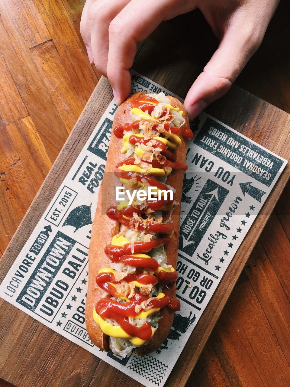 Close-up of human hand holding food on table