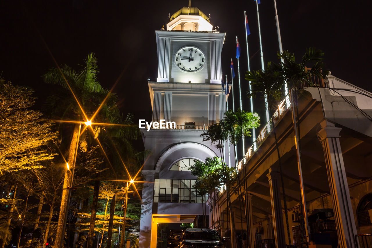 LOW ANGLE VIEW OF ILLUMINATED BUILDING AGAINST SKY