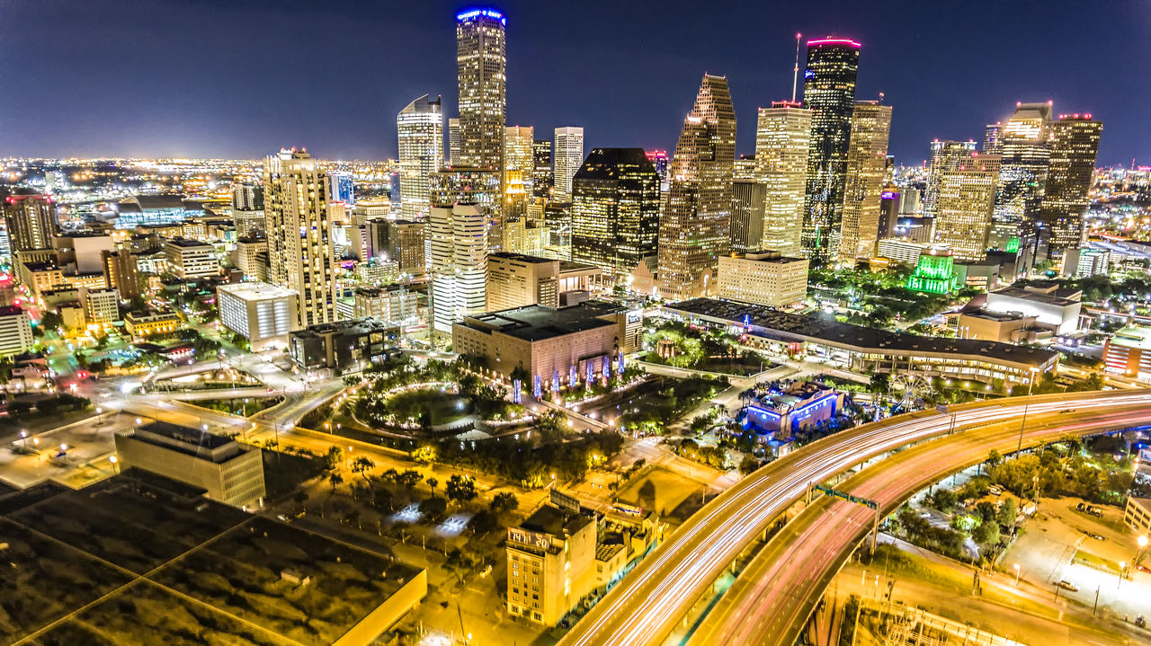 High angle view of city lit up at night