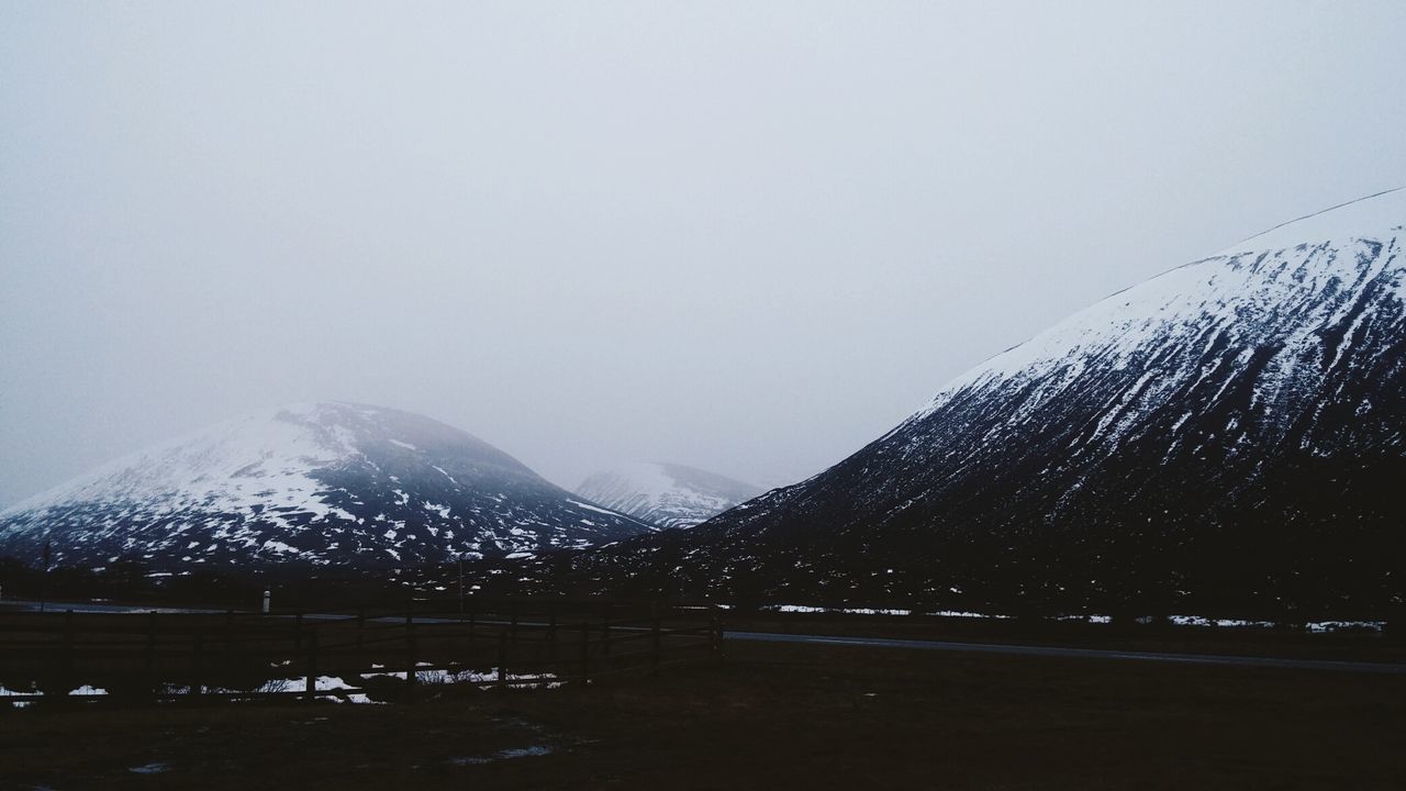 Scenic view of snow covered mountains against sky