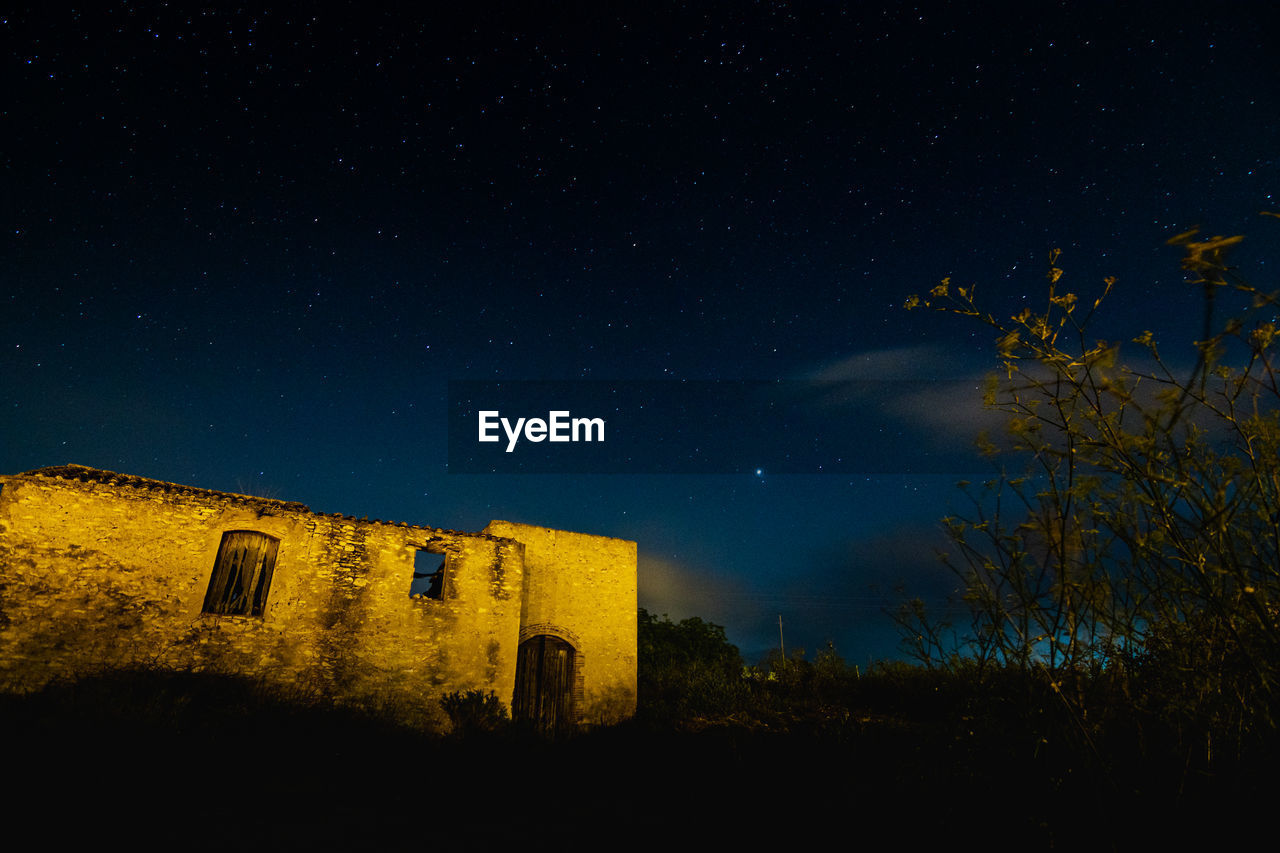 Low angle view of an old building against the sky at night