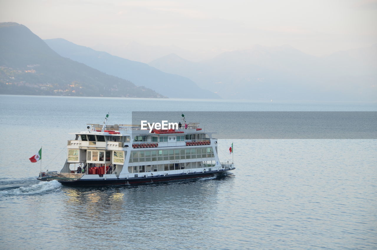 Scenic view of ferry on lake against sky