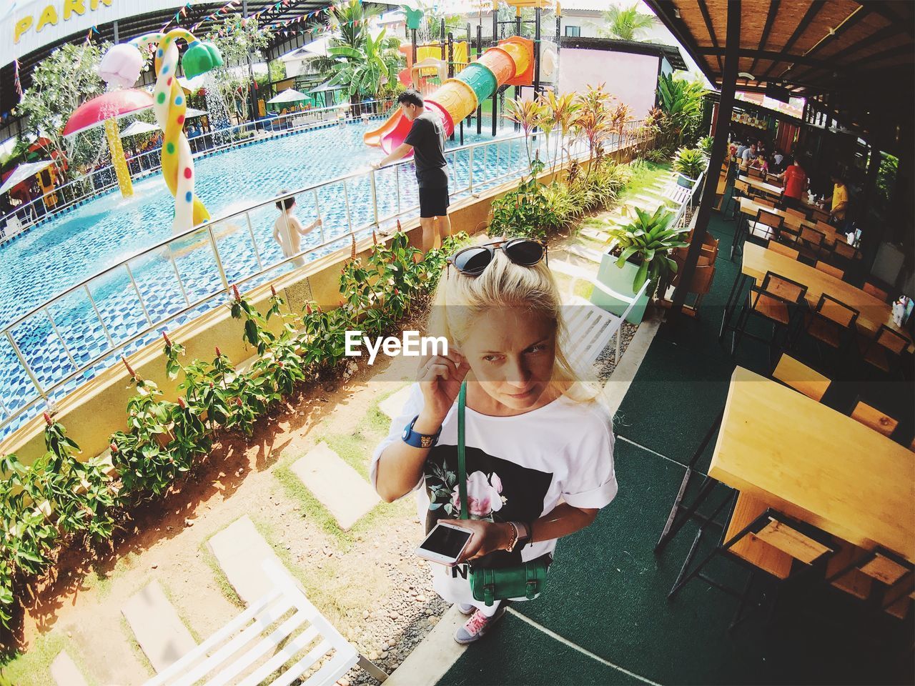 HIGH ANGLE VIEW OF GIRL STANDING AGAINST BUILDING