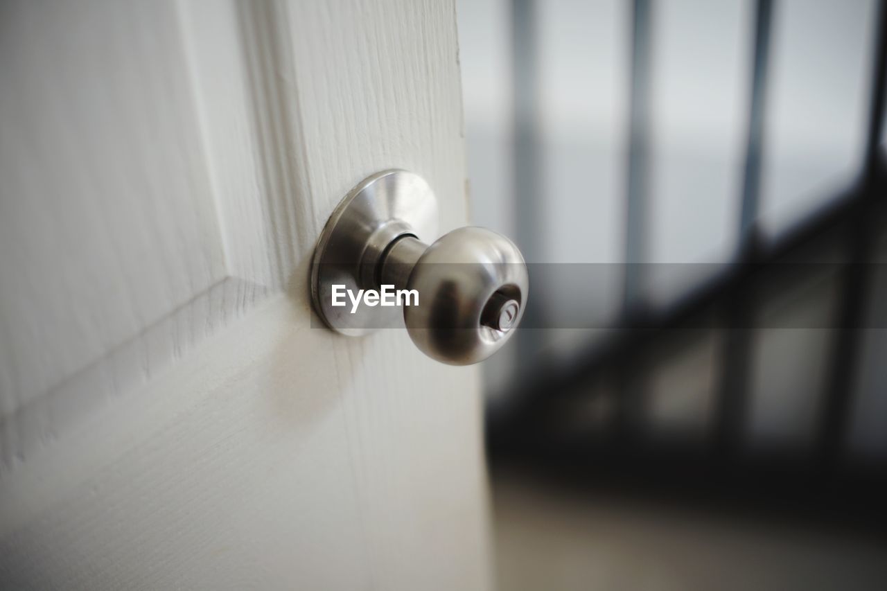 CLOSE-UP OF DOOR KNOCKER ON WALL