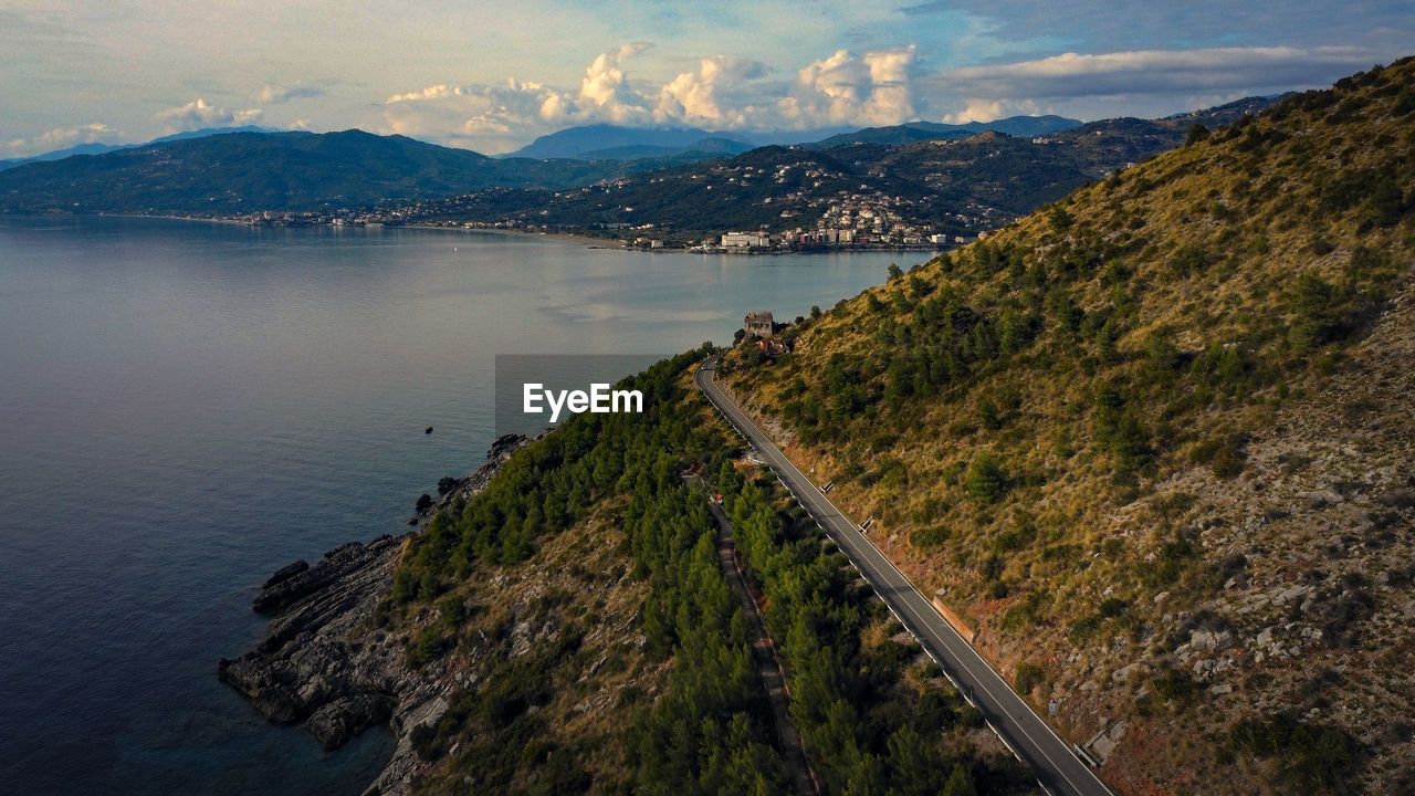 high angle view of townscape by sea against mountain