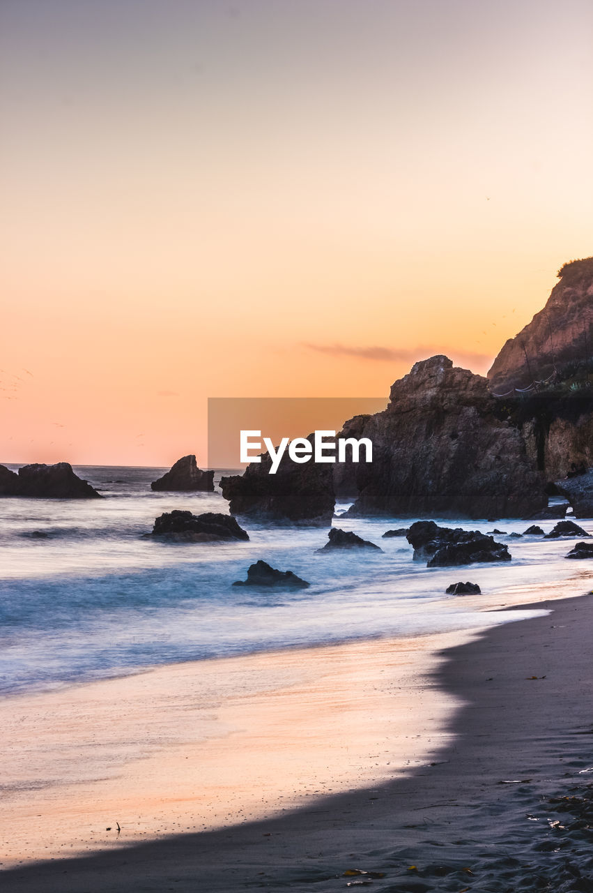 SCENIC VIEW OF BEACH DURING SUNSET